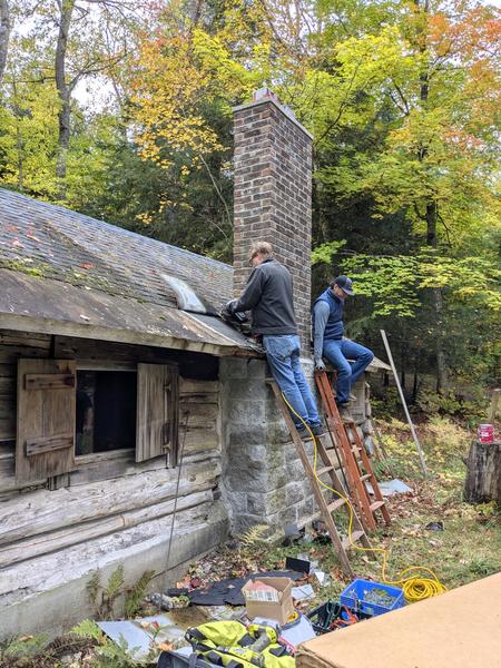 Bill and Mikey prepping the roof around the chimney.