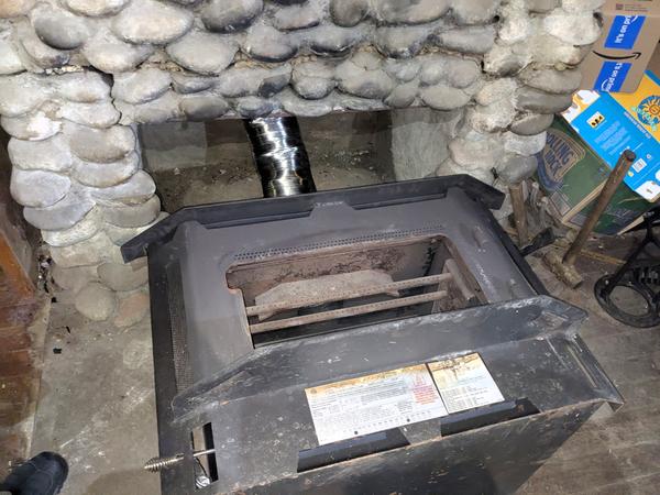 Insert on its back with flue pipe attached in an attempt to get it back into the chimney.