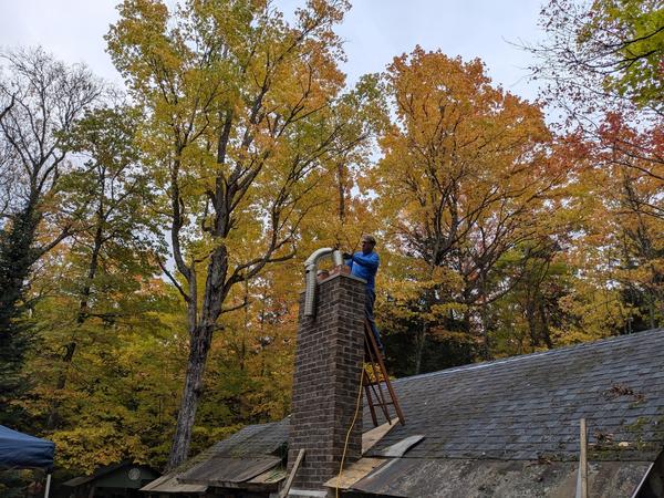 Bill cutting off the excess from the flue pipe.