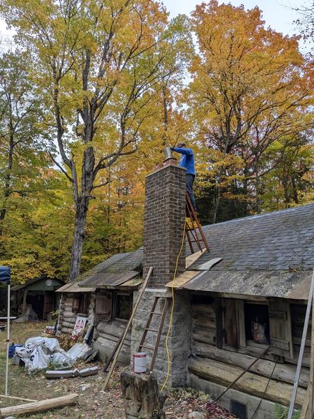 Bill making final adjustments of the flue pipe before capping it off.