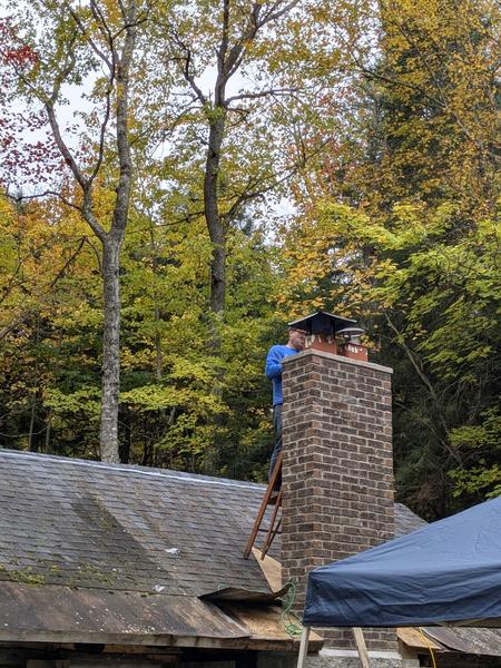 Bill putting the caps on the chimney.