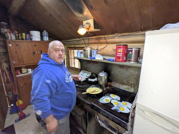 Jon making breakfast inside.