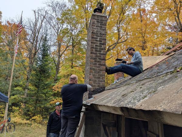 Jon confirming measurements for the flashing to place around the chimney.
