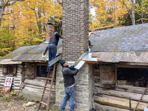Bill cutting some flashing around the chimney to size.