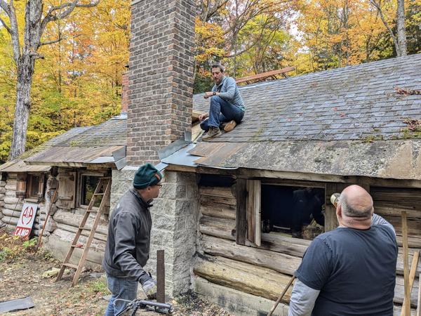 Jon taking a drink of "Old Corn" prior to finishing the install of the roof saddle.