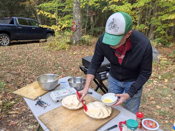 Ed putting an egg wash on the apple pies.