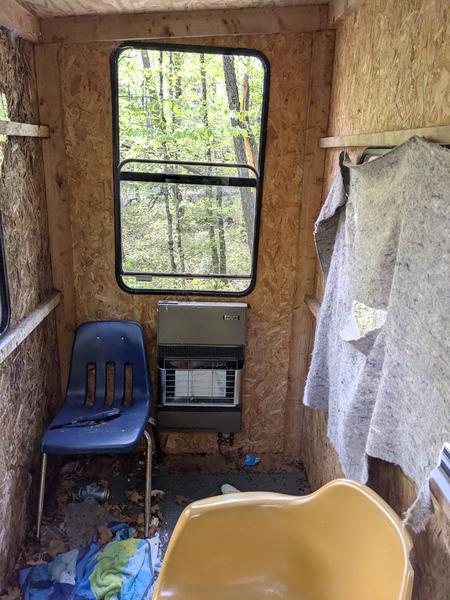 Inside of deer blind for Wolf Camp showing the propane heater.