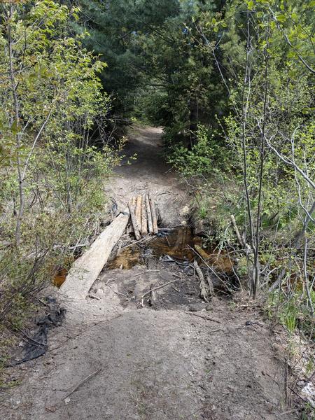What is left of the bridge over Porter Creek on the trail to Barfield Lakes.